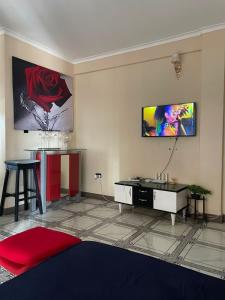 a living room with a flat screen tv on the wall at Alz Haven in Jinja