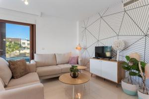 a living room with a couch and a tv at Michael in Torre de la Horadada