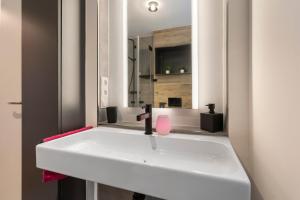 a bathroom with a white sink and a mirror at Traumblick in Bad Liebenzell +13 photos