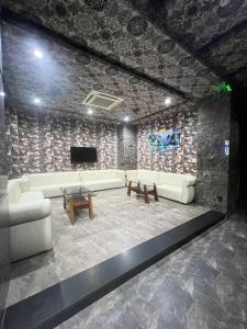 a living room with a couch and a tv at Hola Hotel in Can Tho