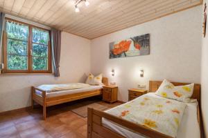a bedroom with two beds and a window at Igelbau in Wolfach