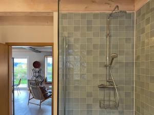 a bathroom with a shower with a glass door at Ferienwohnung Waldmeisterzimmer in Sankt Peter