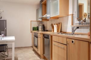 a kitchen with wooden cabinets and a sink at Ferienwohnung Weinberg in Markt Einersheim