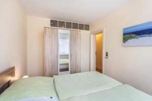 a small bedroom with a bed and a window at Ferienwohnung Figelius in Herscheid