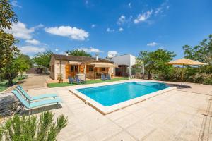 a swimming pool in front of a house at Casita Rafal Roig in Maria de la Salut
