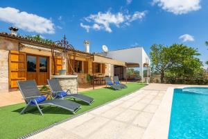 a villa with a swimming pool and a house at Casita Rafal Roig in Maria de la Salut