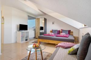 a living room with a bed and a couch at Bergchalet Mirabell - Hofgut in Friedrichshafen