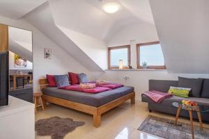 a living room with a bed and a couch at Bergchalet Mirabell - Hofgut in Friedrichshafen