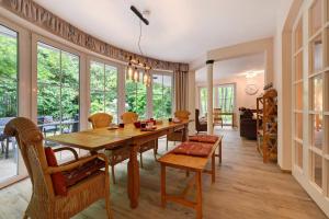 a dining room with a wooden table and chairs at Ferienhaus im Grünen in Harsefeld