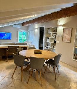 a dining room with a wooden table and chairs at Villa Romantica Lake Idro in Bagolino