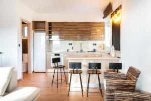 a kitchen with a counter and stools in a room at Mont' Rock villas 2 in Posidhonía