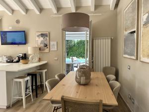 a dining room with a wooden table and chairs at Villa Romantica Lake Idro in Bagolino