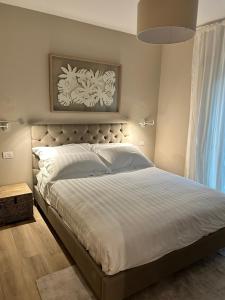 a bedroom with a large bed with white sheets at Villa Romantica Lake Idro in Bagolino +37 photos