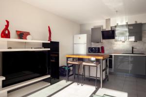 a kitchen with a table and a counter top at Appartement Evasion in Marseille