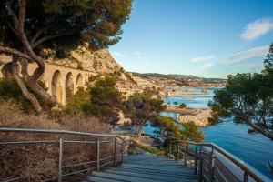 a bridge over a river next to a body of water at Appartement Evasion in Marseille