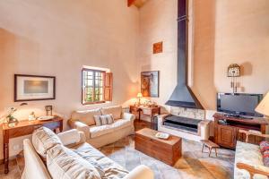a living room with a couch and a fireplace at Son Garrot in Santanyi