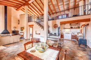 a large living room with a table and a kitchen at Son Garrot in Santanyi
