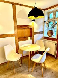 a dining room with a yellow table and chairs at Wohnung In Wolfenbüttel in Wolfenbüttel