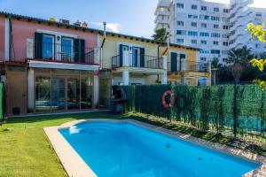 a swimming pool in a yard next to a building at Llac D'alcudia in Port d'Alcudia