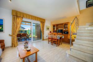 a living room with a staircase and a dining room at Llac D'alcudia in Port d'Alcudia