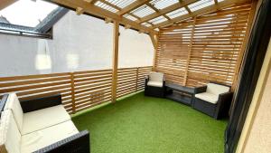 a small room with two chairs and green carpet at Max Haus 2 in Karlstadt