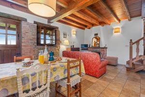 a living room with a table and a red couch at El Ferre in Nava