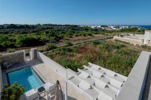 a view of a swimming pool and lounge chairs at Villa Venza , Salento in Otranto