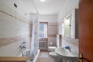 a bathroom with a sink and a toilet and a shower at Appartamenti Adriano Minotto in Falcade +40 photos