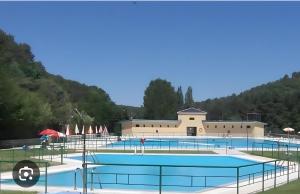 a large swimming pool in front of a building at El Mirador De Campumedra in Vadillo
