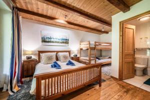 a bedroom with a bed and two bunk beds at Chalet Elisthur in Saint-Jean-d'Aulps