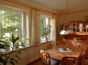 a dining room with a table and a window at Heidtschmidhof Abendsonne in Wolgast