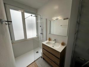 a bathroom with a sink and a shower and a mirror at Ático Cesar Cataldo in Benicarló +23 photos