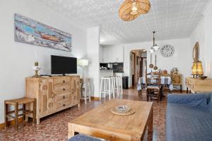 a living room with a couch and a table at Ático Cesar Cataldo in Benicarló