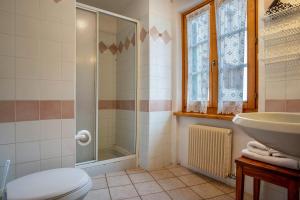 a bathroom with a sink toilet and a shower at Appartamento Moti in Caldes +19 photos