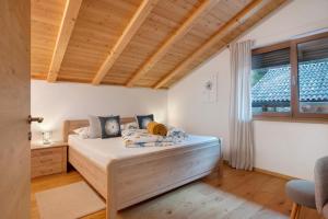 a bedroom with a bed with a wooden ceiling at Löchlerhof in Ritten +106 photos