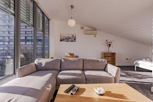 a living room with a couch and a table at Penthouse Split Level 5 min walk to City Centre in Coventry