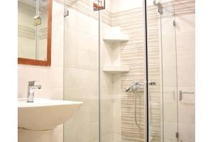 a bathroom with a sink and a shower at Manolika Studio 3 in Kithnos