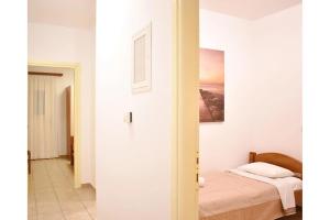 a bedroom with a bed and a painting on the wall at Manolika Studio 3 in Kithnos