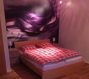 a bedroom with a bed with a painting on the wall at Ferienwohnung Am Sieperloh in Stryck