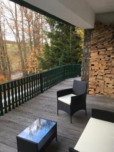 a patio with a table and chairs on a deck at Ferienwohnung Am Sieperloh in Stryck