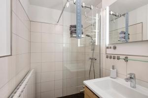 a white bathroom with a shower and a sink at Ferienwohnung Andreas in Naumburg +20 photos