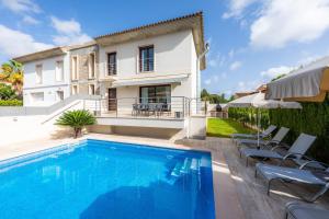 a villa with a swimming pool and a house at Villa Casa Bon Sol in Capdepera