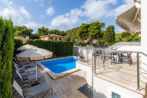 an outdoor deck with a pool and patio furniture at Villa Casa Bon Sol in Capdepera