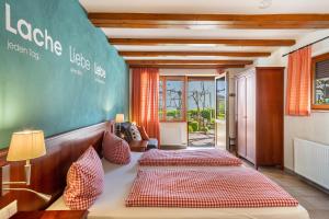 two beds in a room with a green wall at Obst- Ferienhof Ragg in Immenstaad am Bodensee