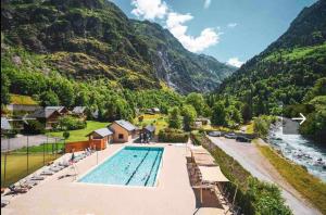 a swimming pool in front of a mountain at Jacuzzi Sauna Terrasse Venosc in Les Deux Alpes