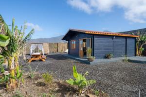 a small shed with a picnic table in front of it at Villa Dely in Tazacorte