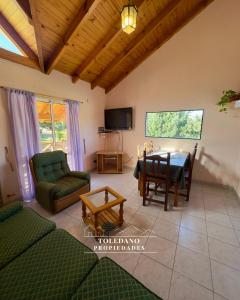a living room with a table and a tv at Costa Azul 4 in Villa Pehuenia