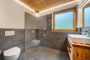 a bathroom with a shower and a toilet and a sink at Oberhaushof in Santa Valpurga +43 photos