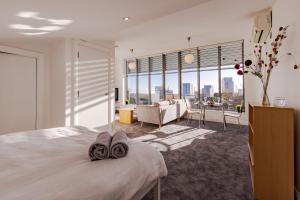 a bedroom with a bed and a living room at Penthouse Split Level 5 min walk to City Centre in Coventry