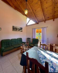 a living room with a couch and a table at Costa Azul 4 in Villa Pehuenia +6 photos